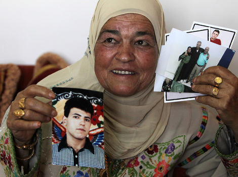 Palestinka drži fotografije svog zarobljenog sina (Foto: AFP)