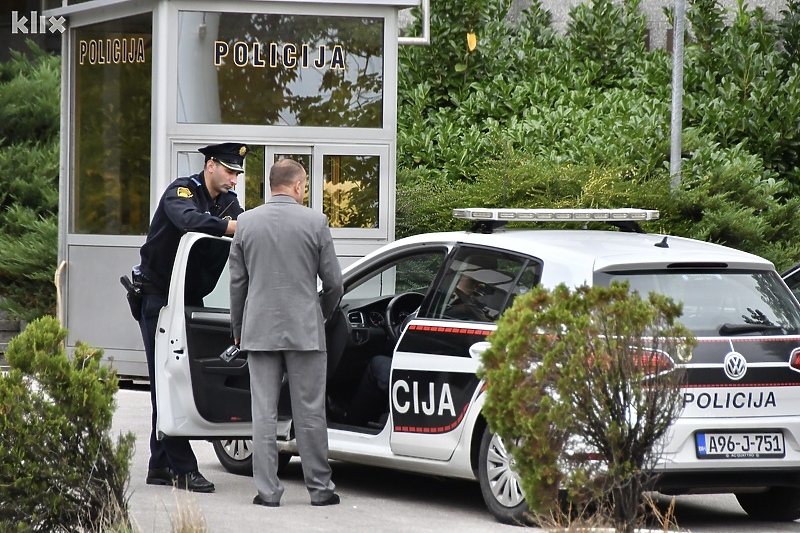 Radnik osiguranja objekta s policijom ispred zgrade Vlade (Foto: I. Š./Klix.ba)