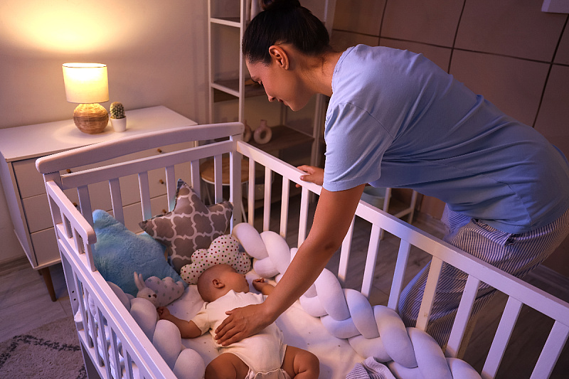 Which items should you not place in a baby's crib due to suffocation hazards?